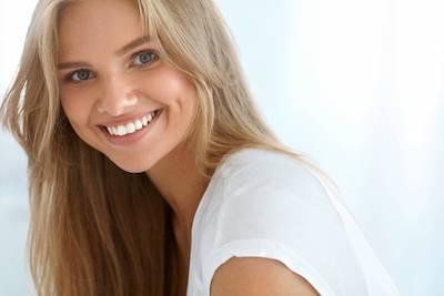 woman smiling after getting her teeth whitened