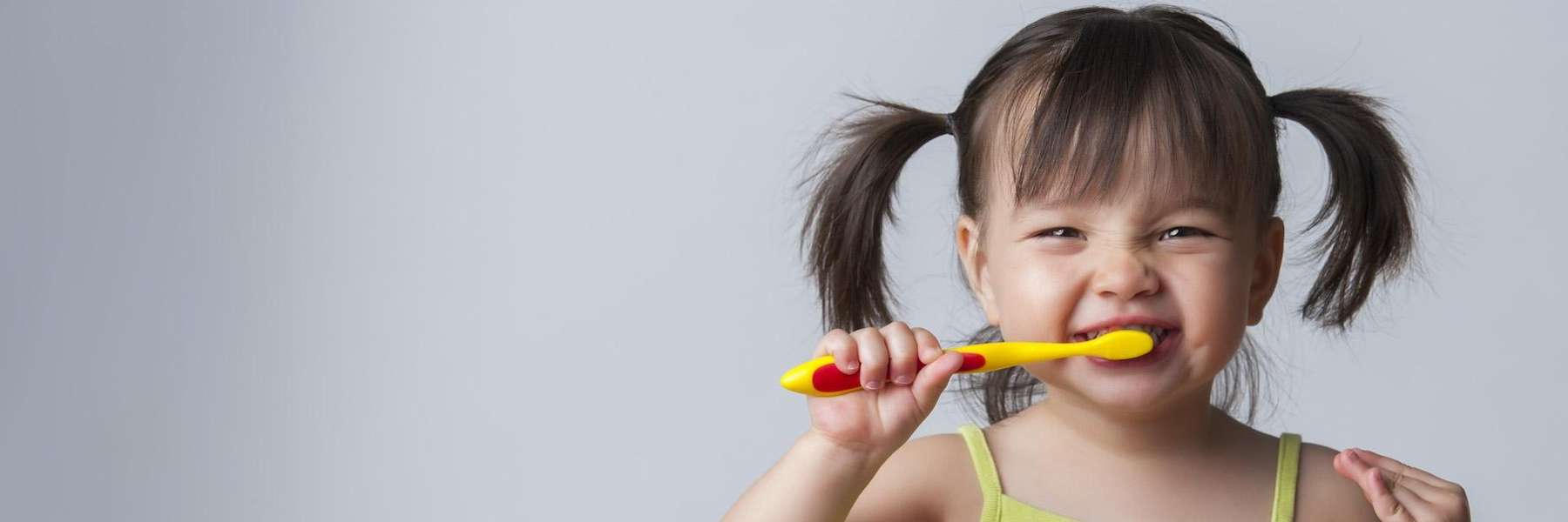 Young asian girl brushing teeth, south austin tx