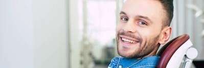 man sitting in dental chair in Austin dental clinic
