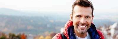 Man smiling while hiking