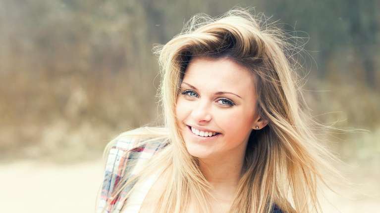 woman smiling after using invisalign