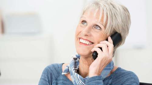 Older woman smiling with a phone, south austin tx
