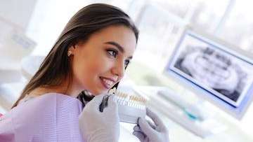 woman smiling while getting teeth whitening in Austin