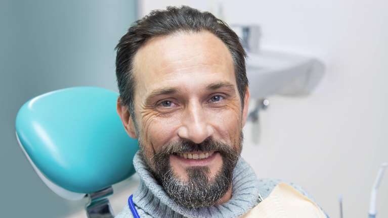 A man smiling in the dentist's chair