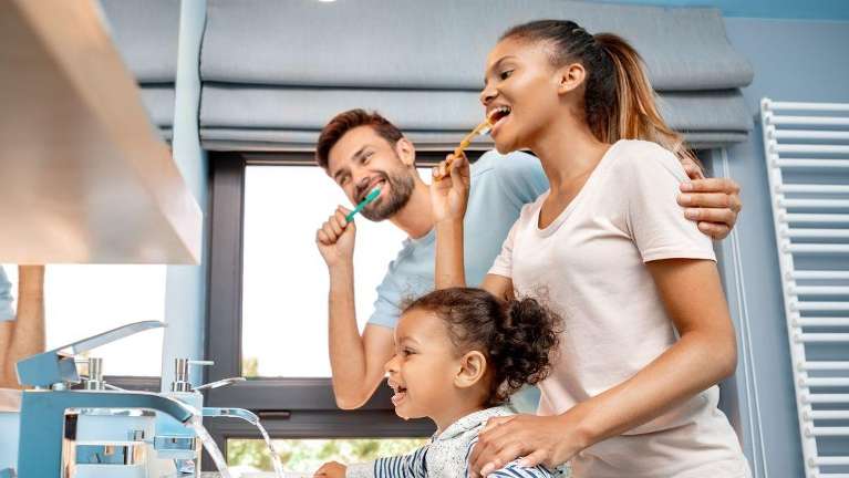 Families Cleaning Their Teeth Together
