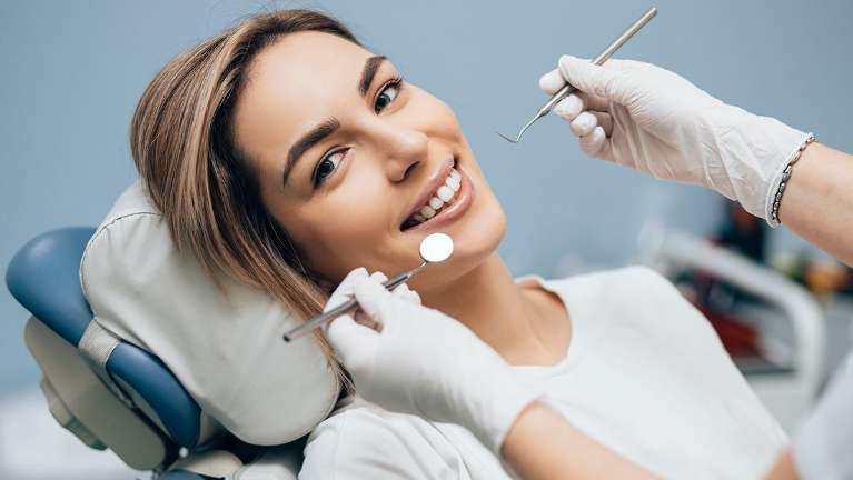 Woman in dental chair smiling, south austin tx