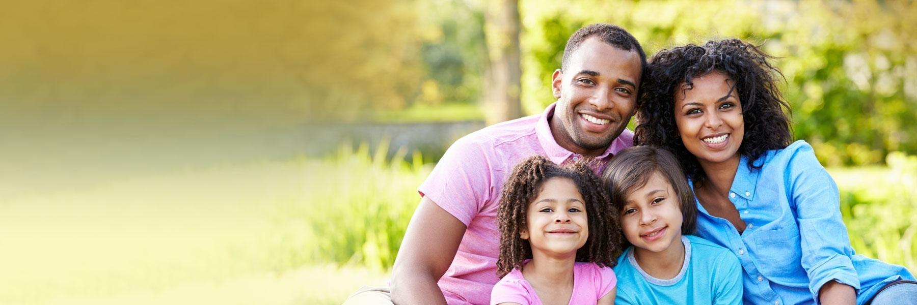 family of four outside smiling l dental emergency south austin tx