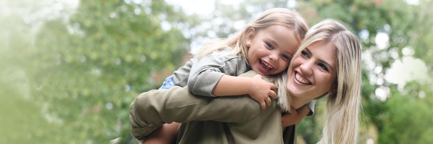 mom & daughter hugging & smiling l periodontal disease treatment austin tx